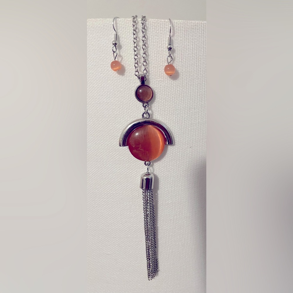 Orange drop silver tone metal necklace.